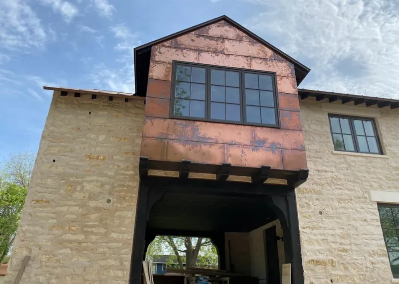 Copper metal panel facade on a stone building for Skylight Installation in Broken Arrow