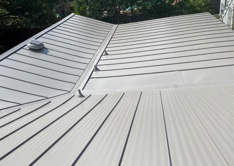 Solar attic fan installed on a metal roof for Roof Ventilation in Broken Arrow